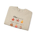 Sweatshirt beige plié orné de feuilles d'automne et de textes bibliques en français.