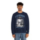 Un homme porte un sweatshirt bleu marine avec une illustration religieuse de Jésus.