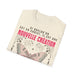 T-shirt beige plié avec un papillon et le texte Si quelqu'un est en Christ, il est une nouvelle création.