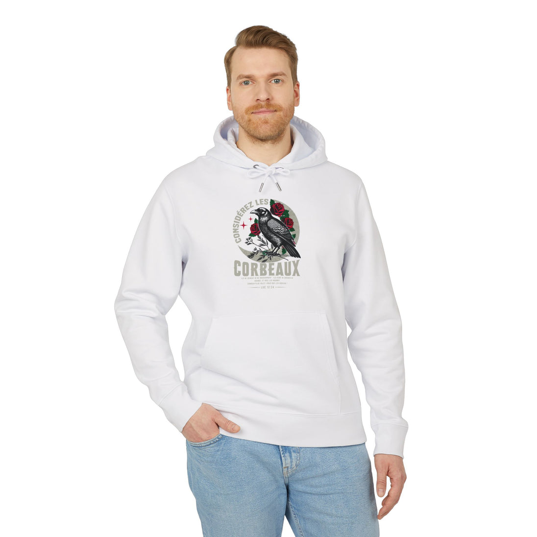 Un homme porte un sweat à capuche blanc avec une illustration de corbeau et de roses.