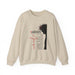 Sweat-shirt beige à col rond avec une illustration du Christ et des inscriptions religieuses.