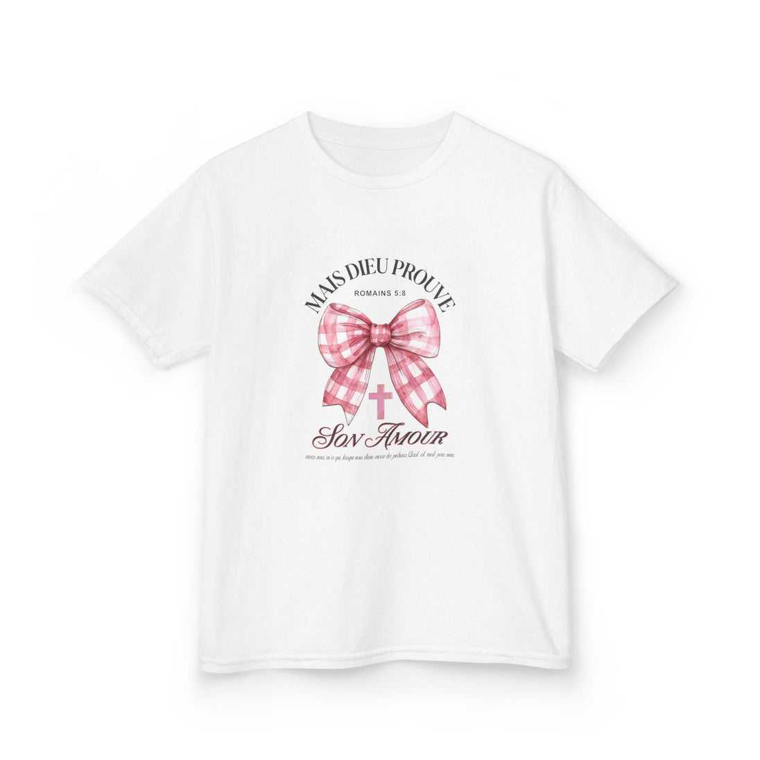 T-shirt blanc pour enfant orné d'un nœud rose à carreaux et d'une croix avec un texte religieux.