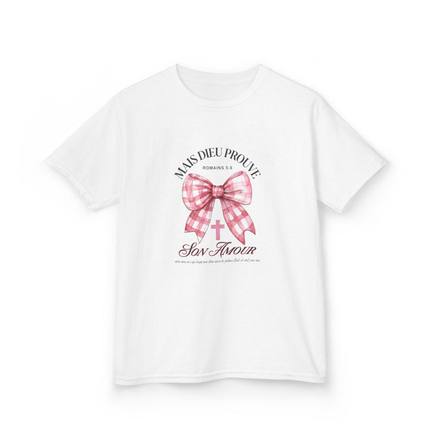 T-shirt blanc pour enfant orné d'un nœud rose à carreaux et d'une croix avec un texte religieux.