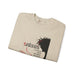 Sweat-shirt beige plié avec une illustration de Jésus portant une couronne d'épines.