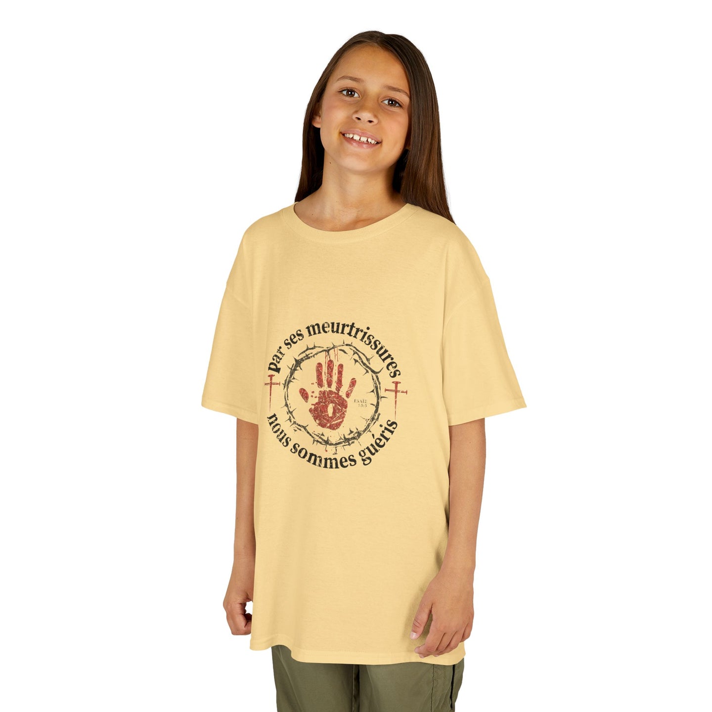 Une jeune fille porte un t-shirt beige en coton avec une impression religieuse centrée.