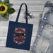 Tote bag bleu marine en coton biologique orné d'un motif floral et du texte Dieu est bon.