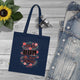 Tote bag bleu marine en coton biologique orné d'un motif floral et du texte Dieu est bon.