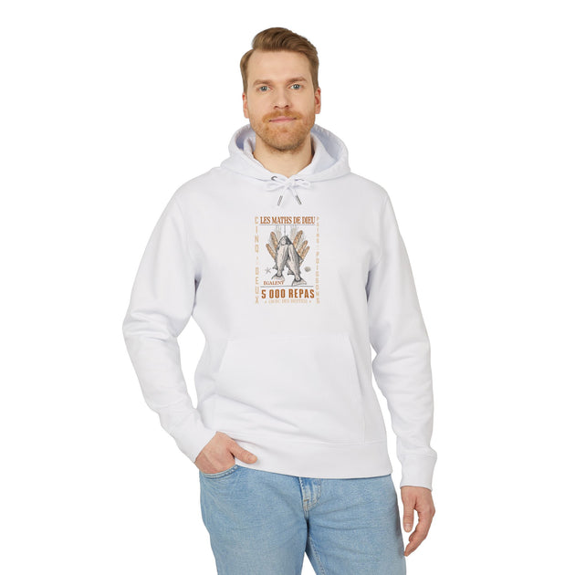 Un homme porte un sweat à capuche blanc avec une illustration chrétienne sur la poitrine.