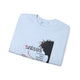 Sweat-shirt bleu clair plié avec une illustration de Jésus et un texte religieux en français.