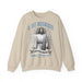 Sweat-shirt beige à col rond avec une illustration religieuse et le texte Il est ressuscité.