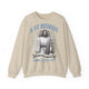 Sweat-shirt beige à col rond avec une illustration religieuse et le texte Il est ressuscité.