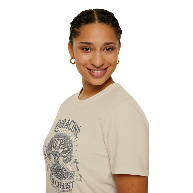 Une femme porte un t-shirt beige en coton avec une illustration d'arbre et le texte Enraciné en Christ.