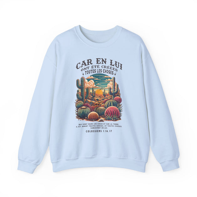 Sweat-shirt bleu clair avec une illustration de désert et un verset biblique en français.