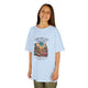 Une enfant porte un t-shirt bleu clair avec une illustration de cactus et un texte biblique.