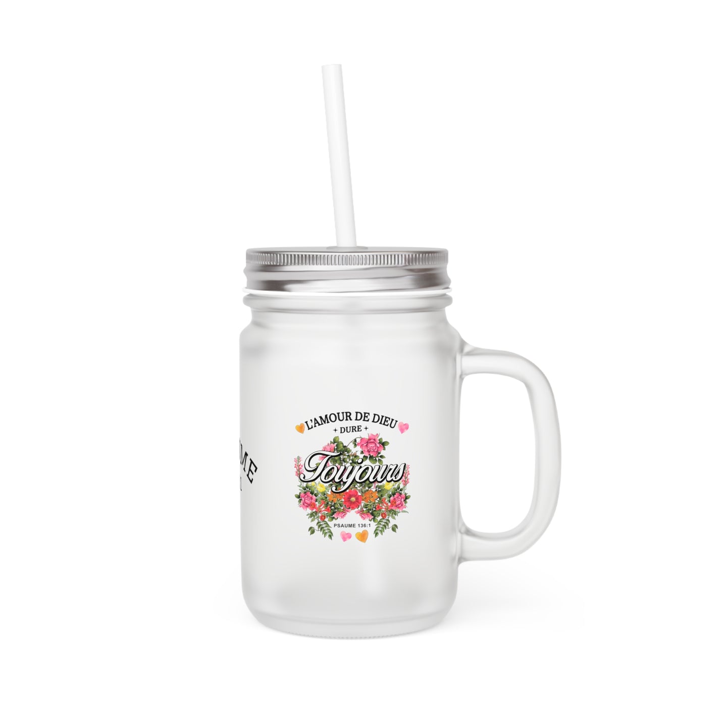 Un bocal en verre dépoli avec couvercle, paille et un motif floral portant l'inscription religieuse.