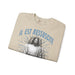 Sweatshirt beige plié avec l'inscription bleue Il est ressuscité et une illustration de Jésus.