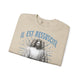 Sweatshirt beige plié avec l'inscription bleue Il est ressuscité et une illustration de Jésus.