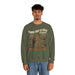 Un homme porte un sweatshirt vert olive avec une illustration de cow-boy et un message religieux.