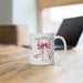 Un mug en céramique blanche orné d'un nœud rose et du verset biblique Jacques 1:17.