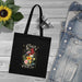 Tote bag noir en coton biologique orné d'un motif floral et de l'inscription Créé avec un objectif.
