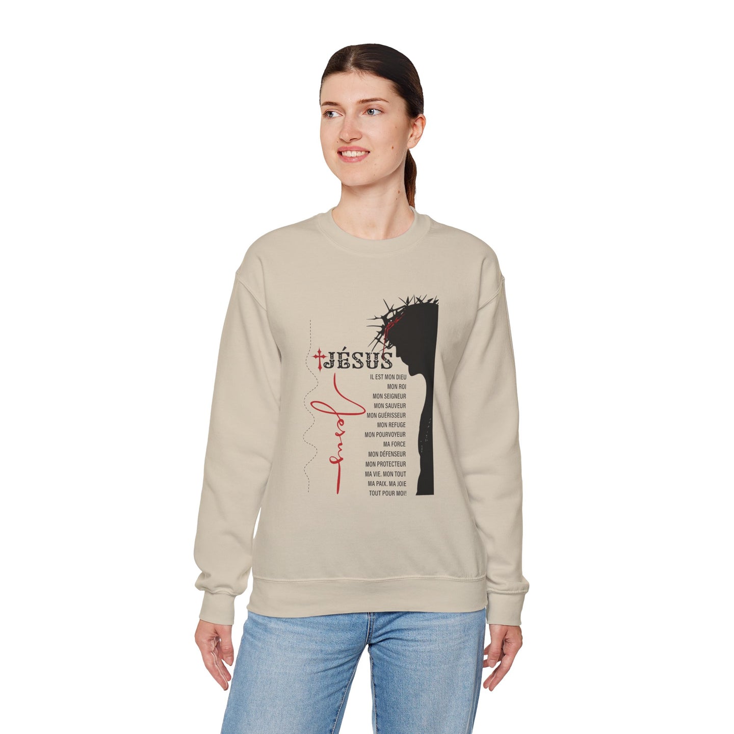Une femme porte un sweat-shirt beige orné d'une illustration religieuse et de textes en français.