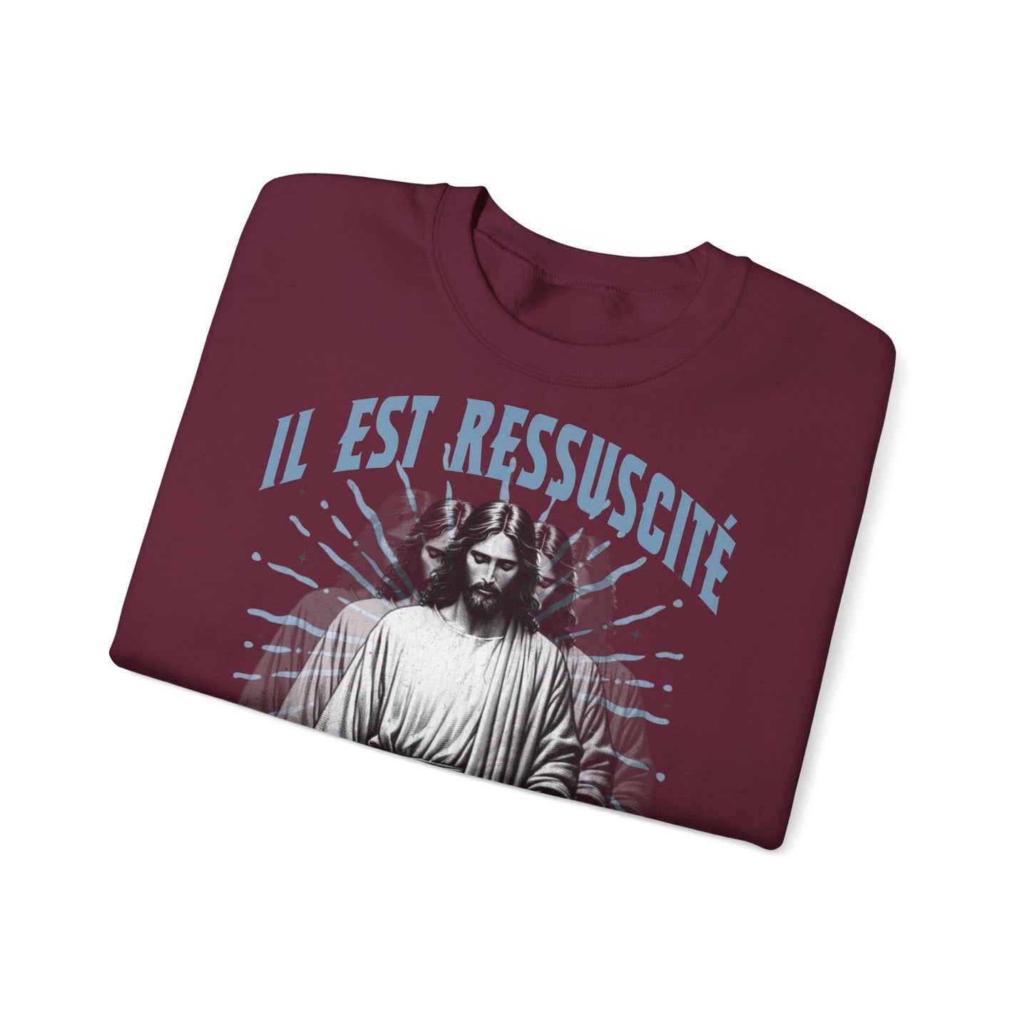 Sweat-shirt bordeaux plié avec une illustration de Jésus et l'inscription Il est ressuscité.