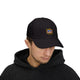 Un homme porte une casquette noire avec le logo brodé Jesus est mon Superhéros.