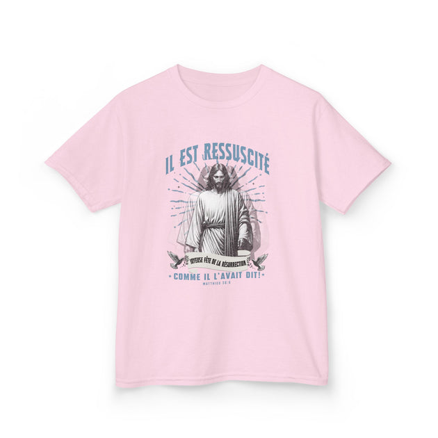 T-shirt rose pour enfant avec une illustration religieuse et le texte Il est ressuscité.